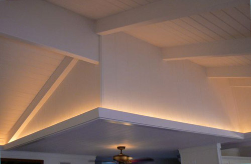 perimeter cove lighting is designed right into the moulding for a lovely soft glow in the evenings